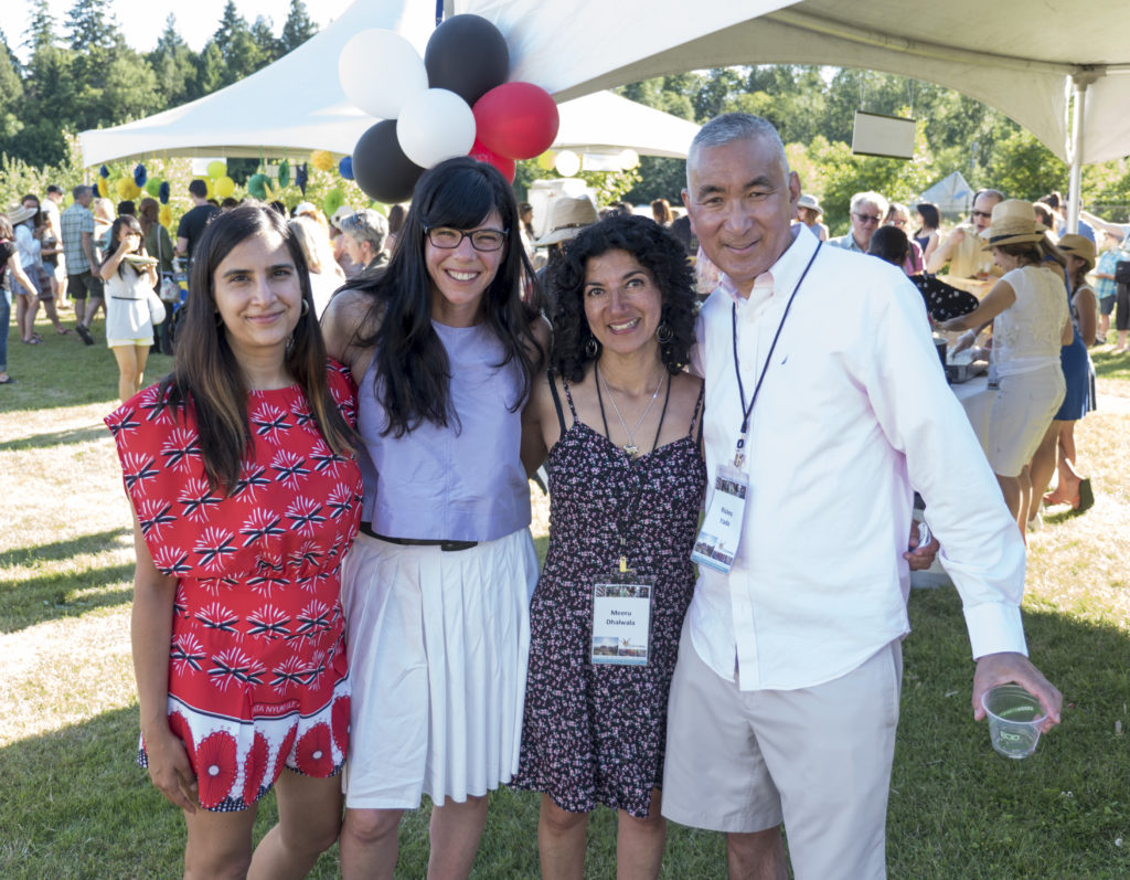 A group of four people pose for a photo at the Joy of Feeding event at UBC Farm.