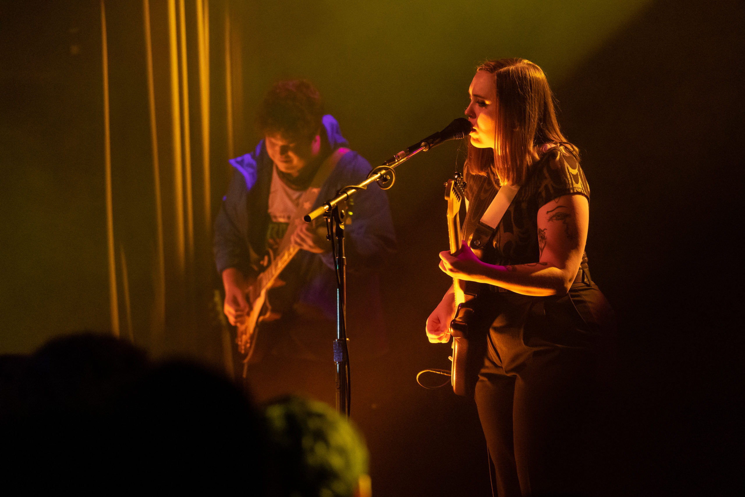 Yellow light showers Soccer Mommy on the stage of the Commodore Ballroom.