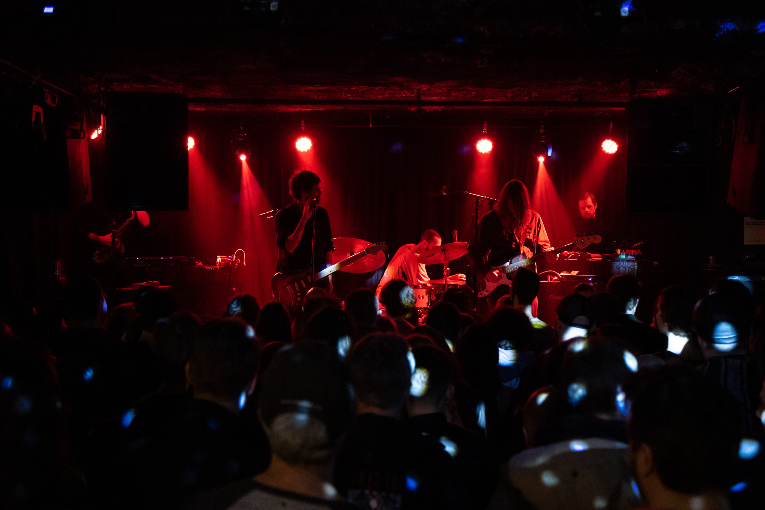 Suuns play the Cobalt bathed in red light and speckled with dots from a disco ball