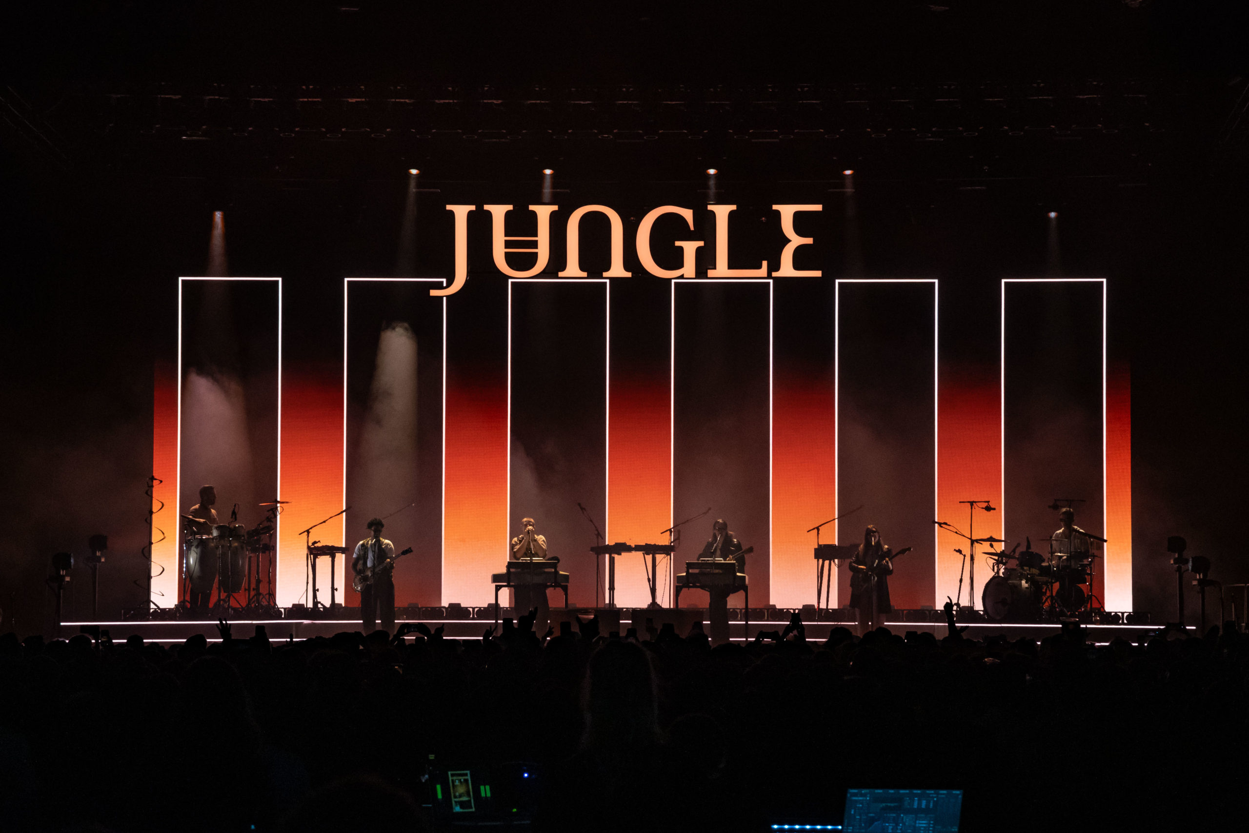 Jungle is backlit by rectangles around each band member, under their giant overhanging logo