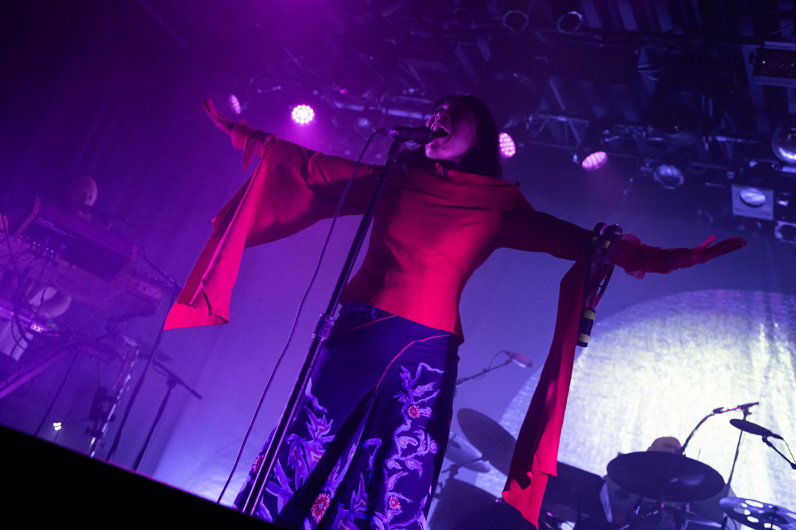 The lead singer of Little Dragon spreads her arms and sings on the stage at the Commodore Ballroom
