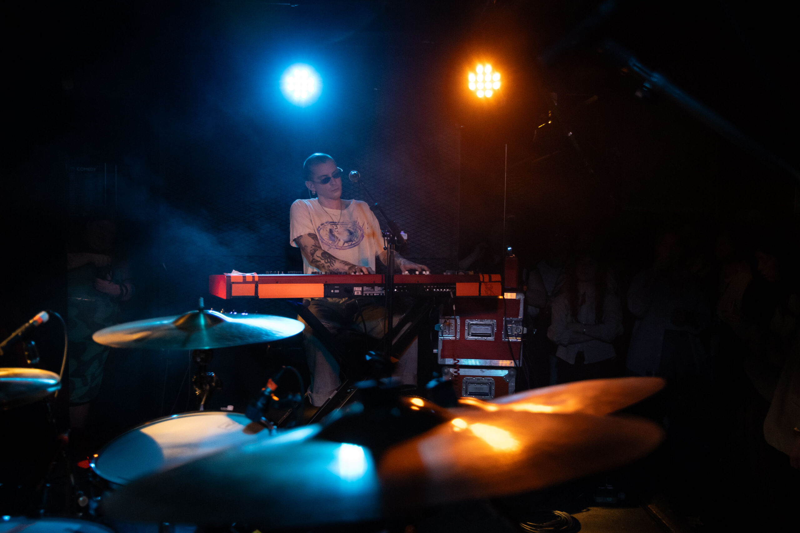 Trevor Powers of Youth Lagoon is surrounded by orange and blue light as he plays the keyboard at the Biltmore Cabaret